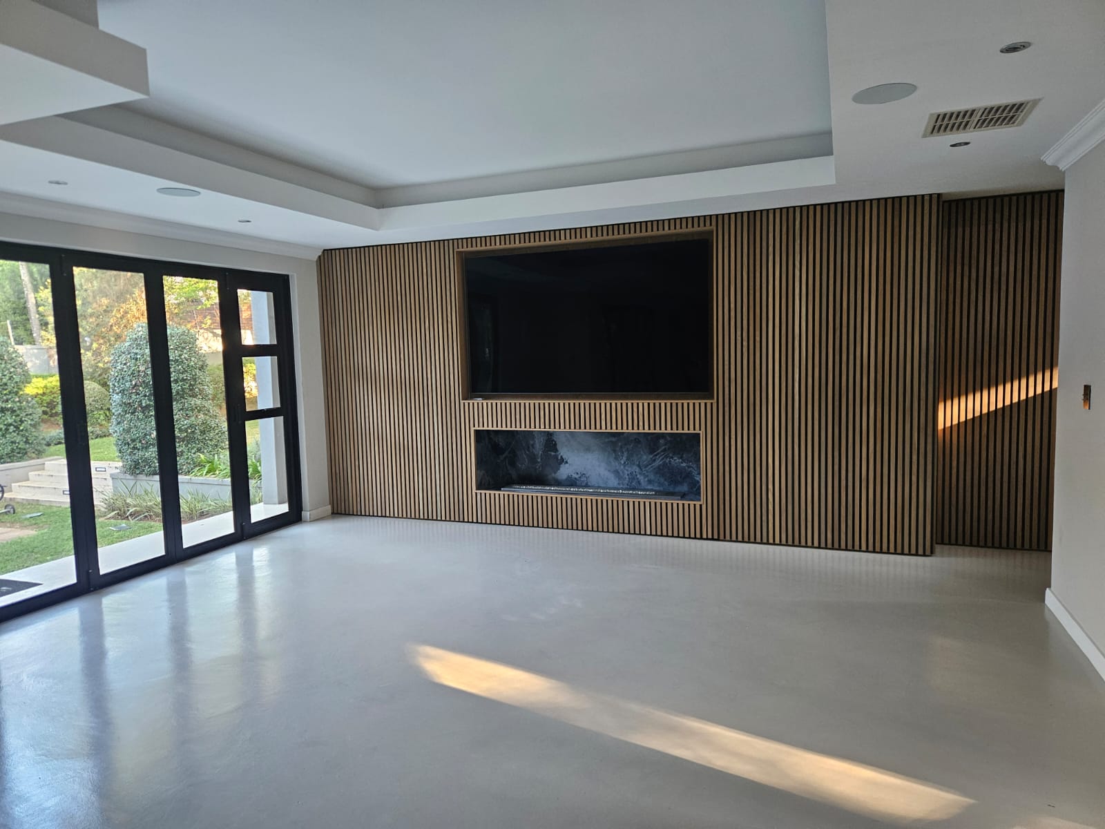 Timber slat feature wall with recessed TV niche and linear fireplace