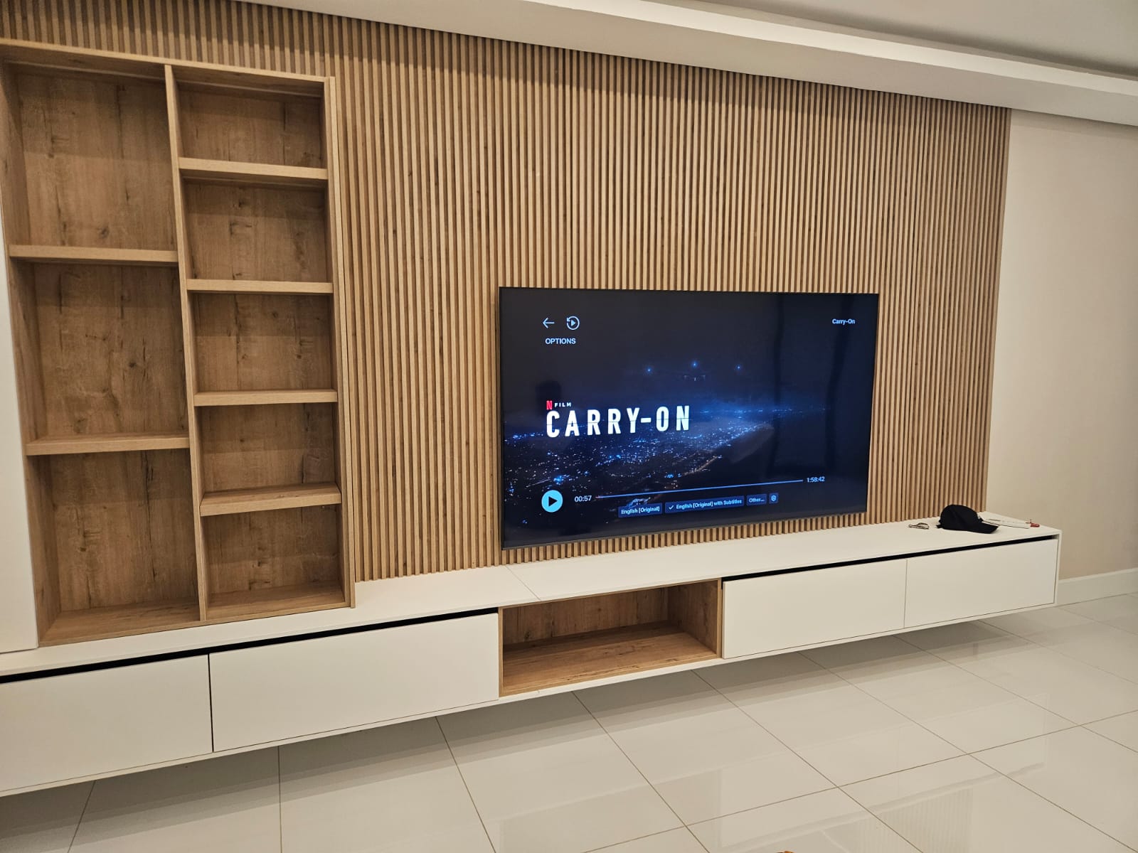 Slatted timber feature wall with recessed TV and floating cabinetry